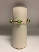 Load image into Gallery viewer, Jewelry display with a gold earring featuring green beads on a gray background
