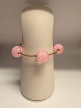 Load image into Gallery viewer, Pink gemstone earring on a beige stand against a neutral background

