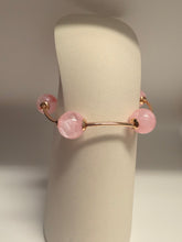 Load image into Gallery viewer, Pink beaded earring on a white stand with a neutral background
