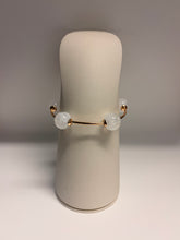 Load image into Gallery viewer, Jewelry display with a bracelet on a cylindrical stand against a neutral background
