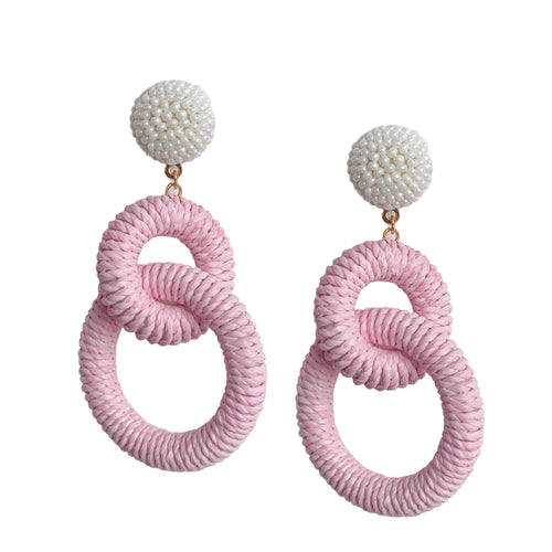 earrings with two pink colored Raffia loops dangling from a circle of tiny pearl beads