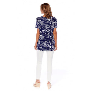 woman in a blue and white striped shirt and white pants