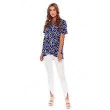 Load image into Gallery viewer, woman in a blue and white striped shirt and white pants

