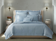 Matouk Nocturne Den Linens on a bed