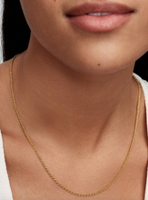 Load image into Gallery viewer, Gold necklace worn by a person with a neutral background
