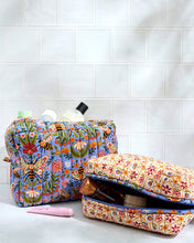 Load image into Gallery viewer, two fabric bags one with a blue print the other with a cream print filled with makeup, soaps and lotion
