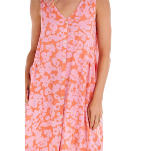 woman in a orange and pink floral dress with button up the front