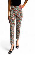 Woman wearing colorful floral pants on a white background