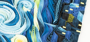 close up of blue black and yellow quilled paper