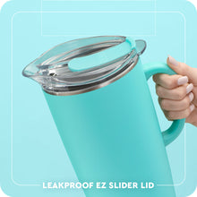 Load image into Gallery viewer, person holding the Swig Lemon Meringue Party Pitcher 64oz text with leakproof ez slider lid
