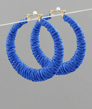 Load image into Gallery viewer, Blue hoop earrings on a gray background
