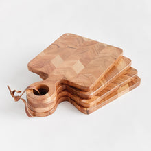 Load image into Gallery viewer, four small wood cutting board with wood handles tied together with leather
