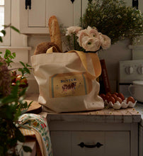 Load image into Gallery viewer, Rifle Paper East West Canvas Tote Bag - Butter holding many items on a counter in a kitchen
