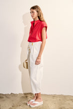 Load image into Gallery viewer, woman in the red Scallop Trim Ric Rac Short Sleeve Shirt paired with white pants
