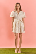 woman in Shell Mini Shirt Dress white dress with appliqué short sleeve and a bow at the waist   