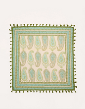Load image into Gallery viewer, A square woven textile with a cream background, featuring a repeating paisley pattern in sage green and light blue. The edges are finished with a border of olive green tassels.
