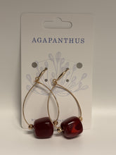 Load image into Gallery viewer, Gold hoop earrings with red beads on a 'Agapanthus' branded card.
