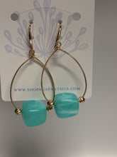 Load image into Gallery viewer, Gold hoop earrings with turquoise beads on a display card.
