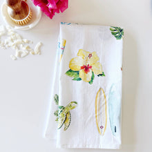 Load image into Gallery viewer, white tea towel with tropical flower, sea turtle and surfboard designs in a watercolor style 

