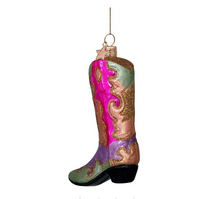 Load image into Gallery viewer, A decorative cowboy boot ornament hanging by a gold wire loop, featuring a green shaft, a bright pink front panel, lavender and rose-gold lower sections, and a black heel on a plain white background.
