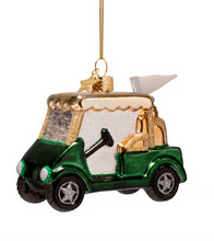 Load image into Gallery viewer, A green and gold golf cart Christmas ornament with a gold hanging string, shown against a plain white background.
