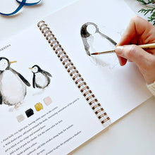 Load image into Gallery viewer, person painting a penguins in the Winter Watercolor Workbook
