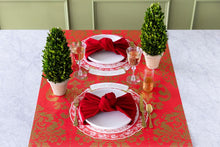 Load image into Gallery viewer,  red paper with gold Damask pattern  set with a place setting 
