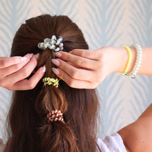 Load image into Gallery viewer, person wearing three ties in her hair and two on her wrist
