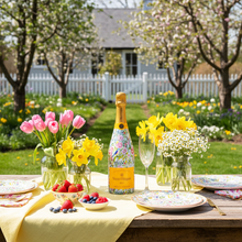 Load image into Gallery viewer, Champagne Bottle covered with the Springtime Serenade Champagne Bottle Wrap on a table set in a garden
