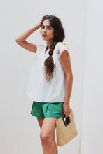 Load image into Gallery viewer, woman in the White Maya Embroidered Blouse paired in green shorts
