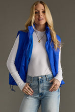 Load image into Gallery viewer, woman in a puffy Classic royal blue Vest paired with a black shirt and jeans
