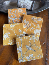 Load image into Gallery viewer, four coasters with black and white bird and floral designs on a yellow background
