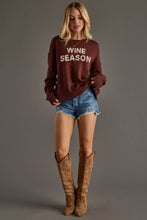 Load image into Gallery viewer, woman in long sleeve maroon sweater with tan text reading wine season ared with jean shorts and cowboy boots

