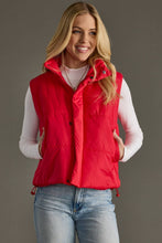 Load image into Gallery viewer, woman in a puffy Classic Red Vest with her hands in the vest pockets
