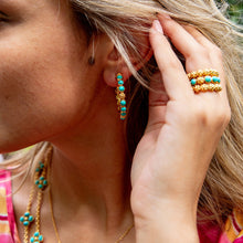 Load image into Gallery viewer, person wearing Capucine de Wulf Berry Gem Turquoise rings and earrings
