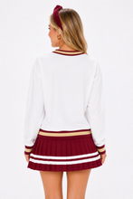 Load image into Gallery viewer, Person wearing a Florida State Heritage V-Neck Pullover  back view showing white fabric and stripes on the hems 
