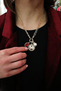 Two strand chain necklace with center loop and three charms
