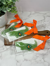 Load image into Gallery viewer, green gummy candy in packaging on a cutting board
