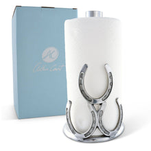 Load image into Gallery viewer, Paper Towel Holder decorated with three horseshoes in a silver color metal and a tall center rod to hold a roll of paper towels  sitting next to a blue Arthur Court branded box
