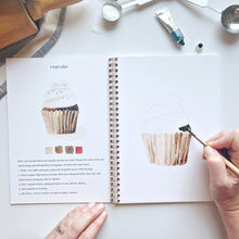 Load image into Gallery viewer, person painting a cupcake frosting
