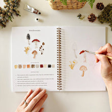 Load image into Gallery viewer, Woodland Watercolor Workbook with person painting mushrooms
