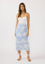 Load image into Gallery viewer, person wearing a blue and white wrap skirt paired with a white tank top and white sandals 
