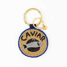 Load image into Gallery viewer, round beaded coin purse set on a gold hoop with a keyring. beads form the word Caviar and an image of a fish
