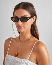 Load image into Gallery viewer, person wearing the Katie Loxton Bordeaux Slim Oval Sunglasses 
