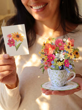 Load image into Gallery viewer, person holding the FreshCut Paper Mini Wildflower Teacup and card
