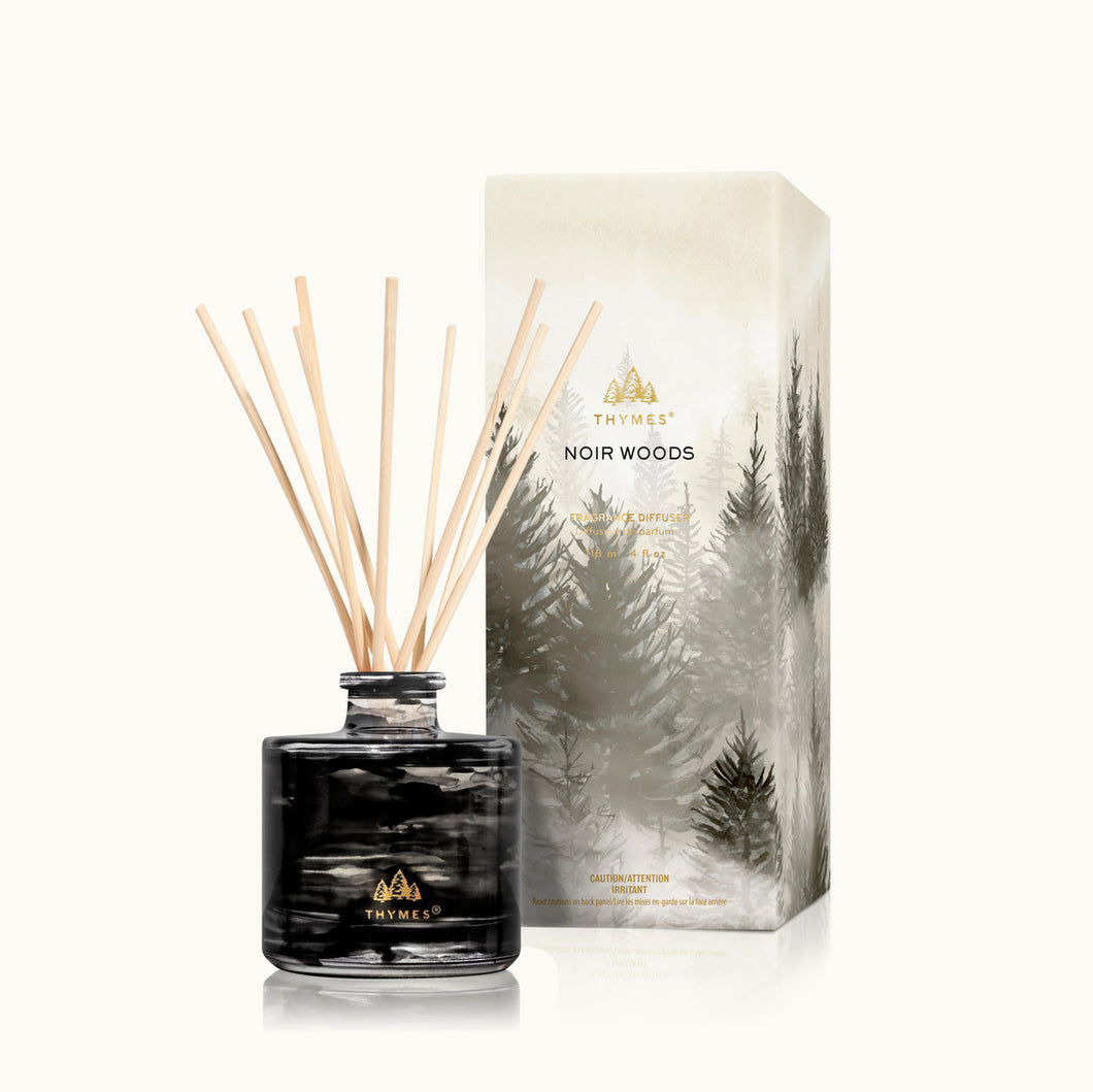 Thymes Noir Woods Petite Reed Diffuser next to branded packaging/box