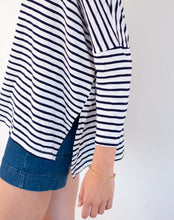 Load image into Gallery viewer, person wearing Mersea Catalina Slub Stripe Ringer Tee white and navy paired with blue shorts view of 3/4 sleeves
