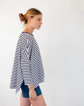 Load image into Gallery viewer, person wearing Mersea Catalina Slub Stripe Ringer Tee white and navy paired with blue shorts side view
