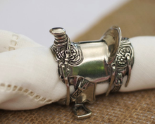 Load image into Gallery viewer, Vagabond House Pewter Cowboy Saddle Napkin Ring on white napkin
